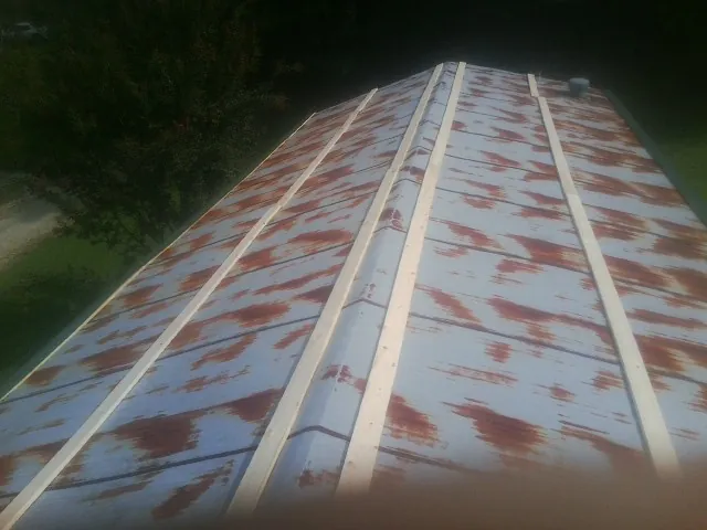 Rusted metal roof panels with new wood purlins before replacement — Storm Damage Roof Repair in Salado by Roofing Brothers